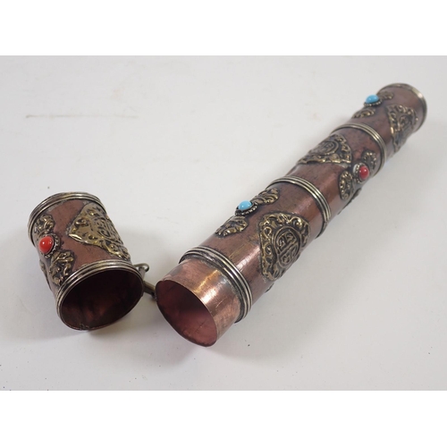 884 - An Indian copper and brass scroll holder inset coloured stones, 24cm