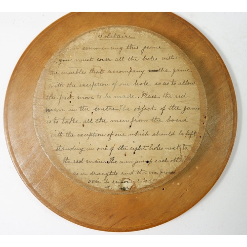 911 - A Victorian solitaire board with marbles stored to base and written instructions, 22.5cm diameter