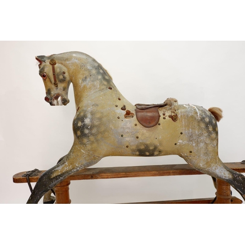 922 - An antique Ayres style dapple grey rocking horse in need of restoration, 120 x 140cm