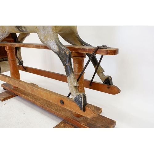 922 - An antique Ayres style dapple grey rocking horse in need of restoration, 120 x 140cm