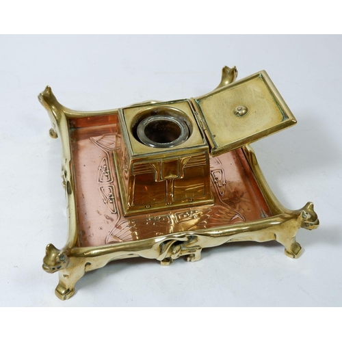 938 - A brass and copper Art Nouveau style inkwell 19cm square