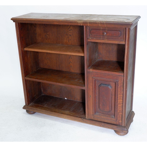 973 - An oak bookcase with drawer and cupboard, 110cm wide