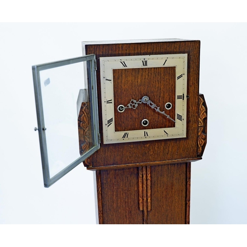 979 - An Enfield oak grandmother clock with key, 140cm tall