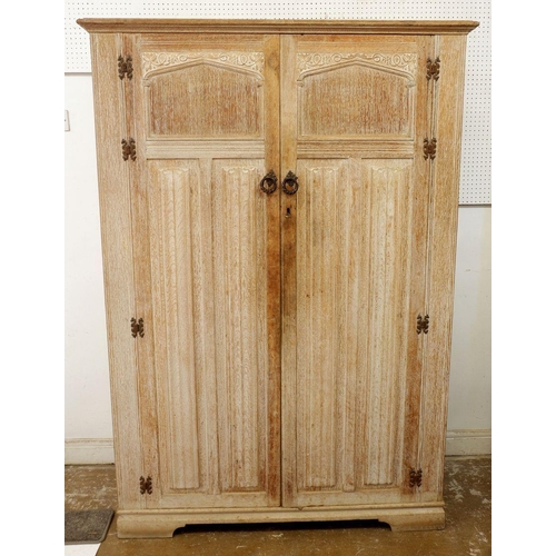 984 - A Crown Ay limed oak two door carved wardrobe