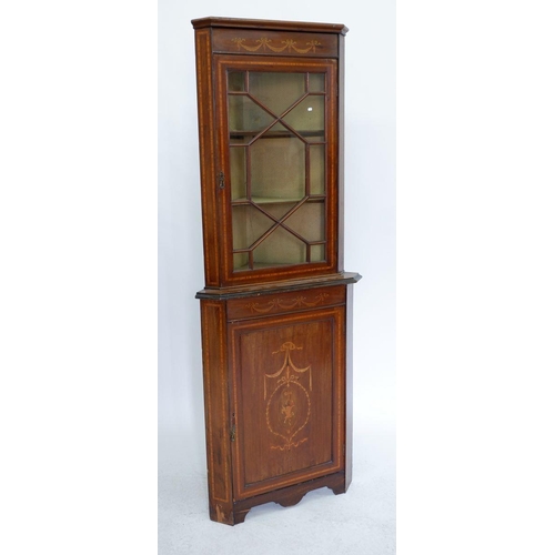 987 - An Edwardian mahogany corner display cabinet with marquetry decoration to cupboard