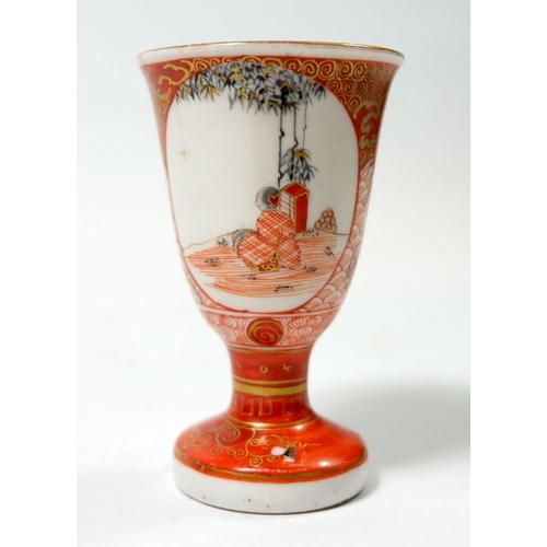 106 - A Japanese Kutuni saki cup painted seated figures on scale reserves, with text to interior, a/f