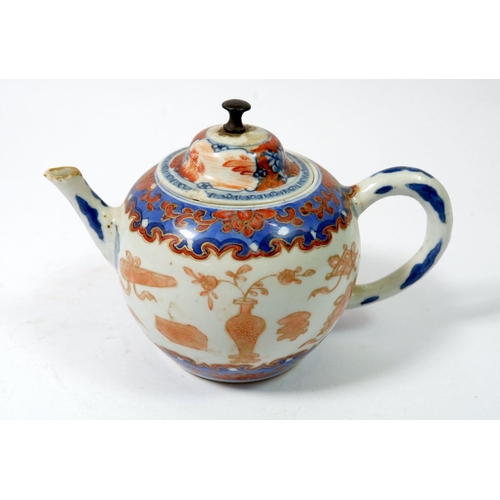 109 - A Chinese 18th century teapot in blue and iron red, 11cm tall - a/f