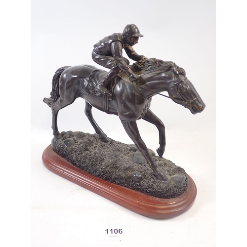 1106 - A bronze finish jockey and horse group, 23cm tall