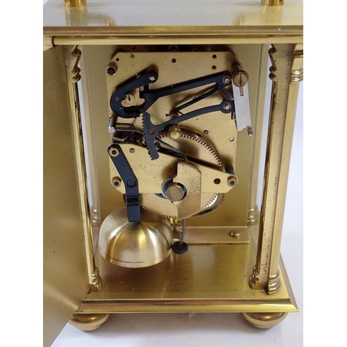 1113 - A Rapport brass striking mantel clock, 14cm tall