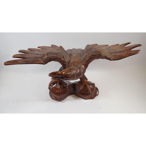 1133 - An American carved wooden eagle, a/f, 46cm wide