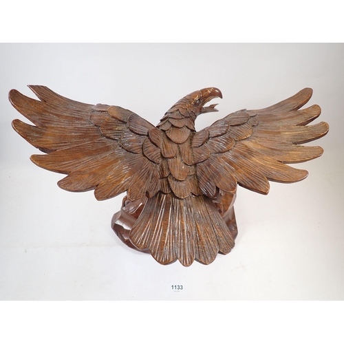 1133 - An American carved wooden eagle, a/f, 46cm wide