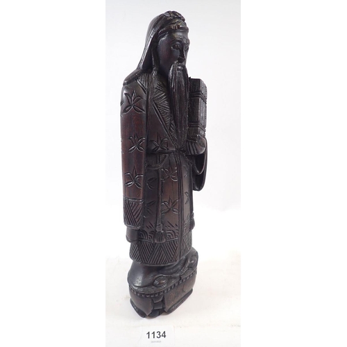 1134 - A Chinese carved wood figure of a deity, 31cm