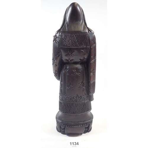 1134 - A Chinese carved wood figure of a deity, 31cm