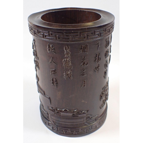 1141 - A Chinese hardwood brush pot carved pagoda landscape and text, 15cm tall