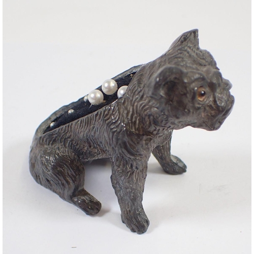 1163 - A Victorian pewter model of lion 8cm long and a spelter bull dog pin cushion with glass eyes