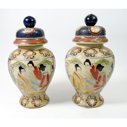117 - A pair of Japanese Meji period baluster form vases and covers painted seated figures, 27cm