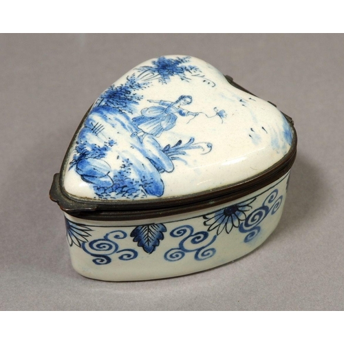 134 - A Dutch Delft heart form trinket box painted woman in landscape, marked AK to base, 7 x 5.5cm