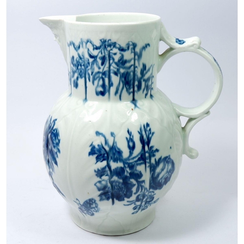 145 - A Worcester first period blue and white mask jug painted floral sprays and butterfly, 22.5cm, cresce... 