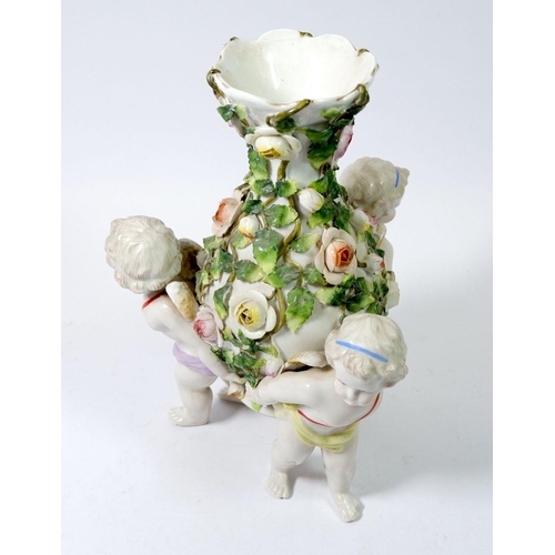 149 - A Sitzendorf baluster vase with applied floral decoration and cherub supports, 24cm tall