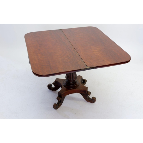 1599 - A Victorian Mahoney fold over card table with tulip carved pedestal on platform base