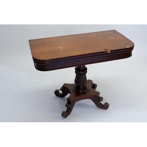 1599 - A Victorian Mahoney fold over card table with tulip carved pedestal on platform base