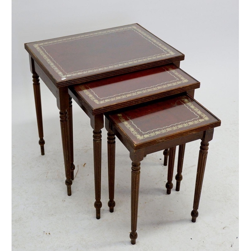 1604 - A nest of three reproduction leather topped occasional tables