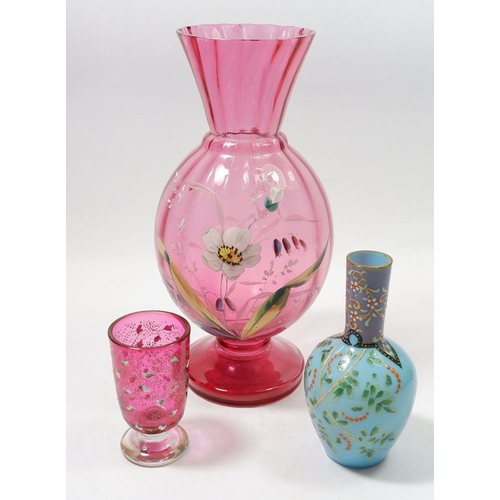 173 - A Victorian cranberry glass vase painted flowers, 26cm and two small enamelled glass vases