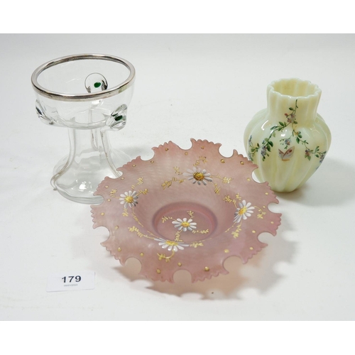 179 - A painted vaseline glass vase, a pink glass dish painted daisies and a trailed glass Powell style go... 