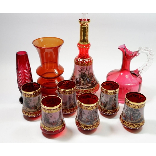 180 - An Italian red glass decanter and glasses set, a cranberry glass jug and two other red glass vases
