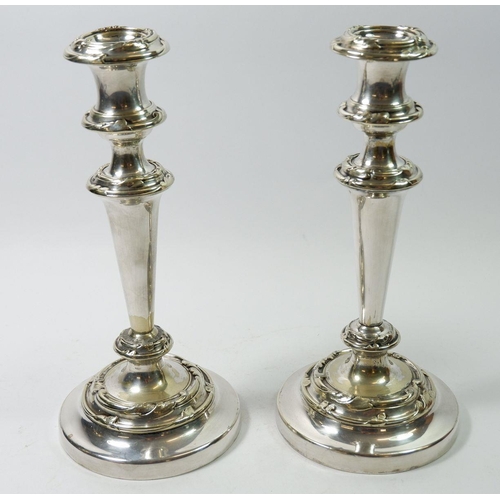 198 - A pair of silver plated candlesticks with scrollwork decoration, 25cm tall