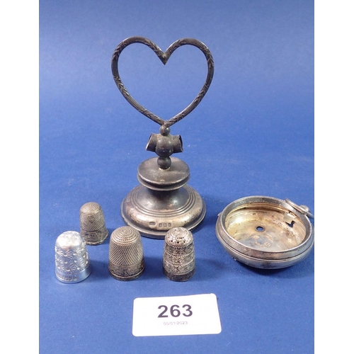 263 - A silver heart form dressing table item a/f, a silver watch case, two silver thimbles and two other ... 