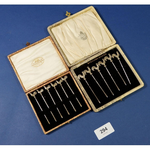 294 - Two cased sets of sterling silver cocktail sticks with cockerel finials