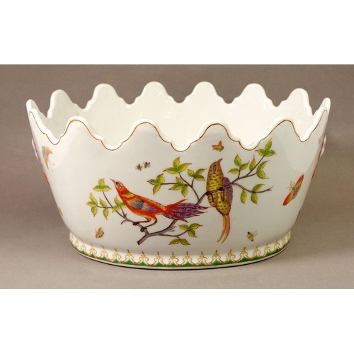 4 - A French porcelain large oval monteith painted birds and lilies with oriental masks to sides, 32cm w... 