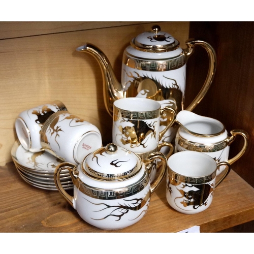 55 - A Japanese gilt and white coffee set comprising: coffee pot, five cups and saucers, milk and sugar
