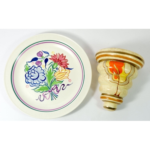 75 - An Art Deco wall pocket painted in the style of Clarice Cliff and a Poole pottery floral plate
