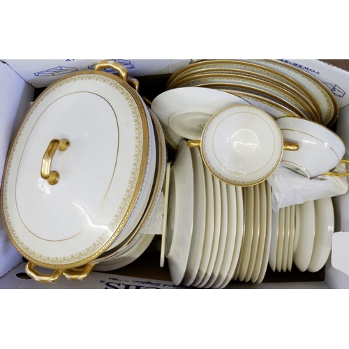 94 - A Limoges C Ahrenfeldt gilt and white dinner service comprising:- seven dinner plates, seven side pl... 