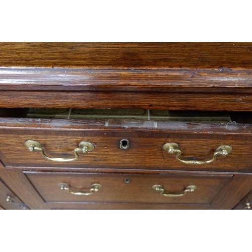 1023 - A part Georgian oak dresser with later back, the base with three frieze drawers over two cupboards a... 