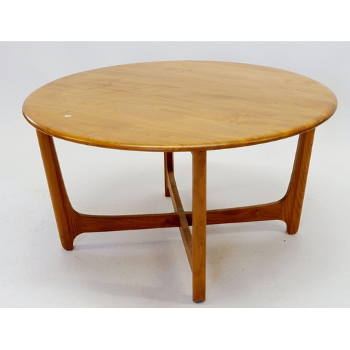 1034 - An Ercol light elm coffee table on four supports united by cross stretcher, 90cm diameter