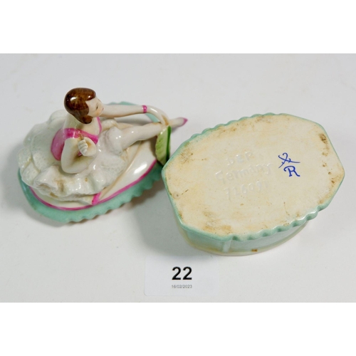 22 - A German porcelain trinket box with seated dancer to lid, 11cm tall