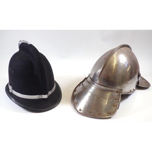 545 - A replica 17th century style helmet with fishtail back and a fake police helmet