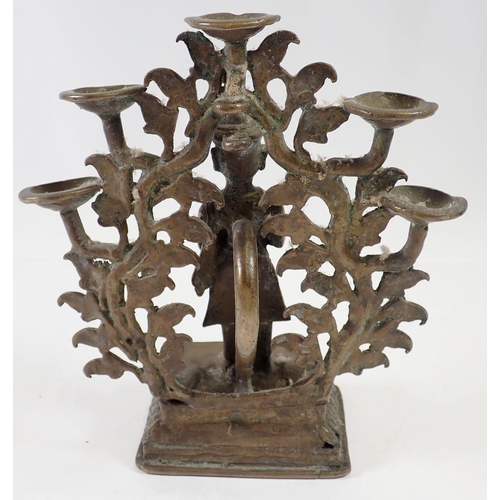 631 - An Indian brass incense burner with praying figure standing by a tree tree holding five oil dishes, ... 