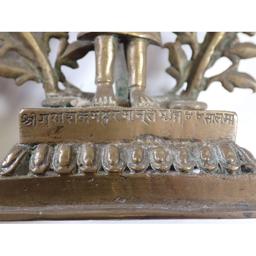 631 - An Indian brass incense burner with praying figure standing by a tree tree holding five oil dishes, ... 