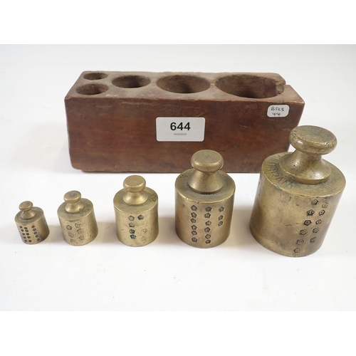 644 - A set of five antique commercial brass weights in wood block with verification punch marks