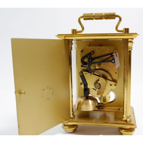 671 - A Rapport brass striking mantel clock, 14cm tall