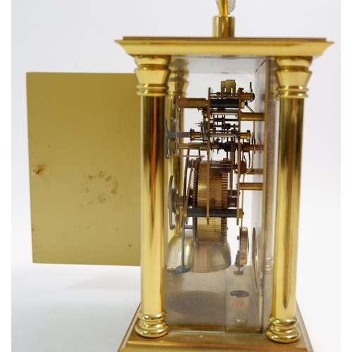 671 - A Rapport brass striking mantel clock, 14cm tall