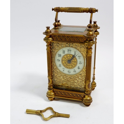 672 - A 19th century fine French brass carriage clock with pierced gilt decoration to front, with key, 12.... 