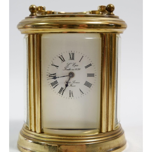 674 - A L'Epee small brass carriage oval clock, cased, 7.5cm tall