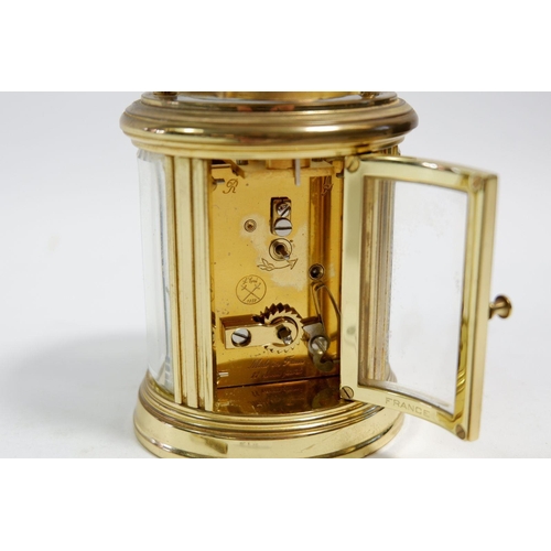 674 - A L'Epee small brass carriage oval clock, cased, 7.5cm tall