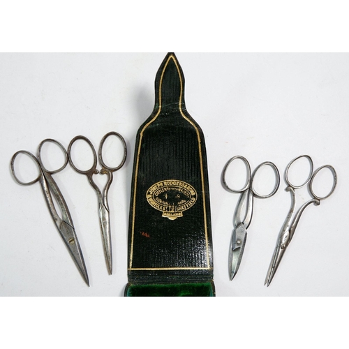 681 - A matched set of antique steel scissors in leather fitted case by Joseph Rogers & Sons