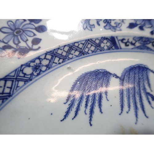 96 - A Chinese Qing Long century blue and white charger painted garden scene, 35cm